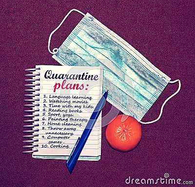 An abstract image of a medical mask and a notebook with plans for what to do while a coronavirus quarantin Stock Photo
