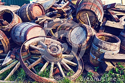 Abstract image with old wooden barrels of alcohol and wheels from the cart Stock Photo