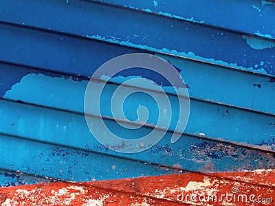 Abstract image of a ship hull in red and blue colors with peeling varnish Stock Photo