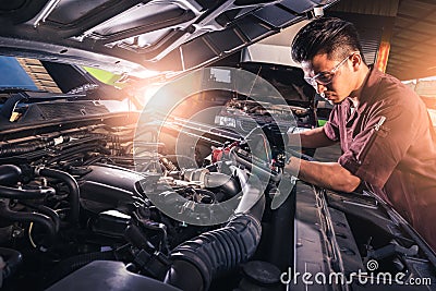 The abstract image of the technician using voltage meter for voltage measurement a car`s battery. the concept of automotive, repai Stock Photo