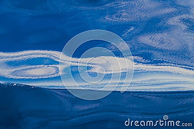 Abstract water background. Calm ocean water surface with curled white reflections Stock Photo