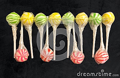 Abstract line of 12 striped lollipops Stock Photo