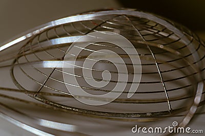 Abstract metallic whisk design casting unique shadows on a neutral background, perfect for creative design projects Stock Photo