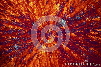 Abstract micrograph of orange and blue lysine crystals. Stock Photo