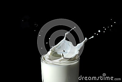 Abstract milk splash against black background Stock Photo