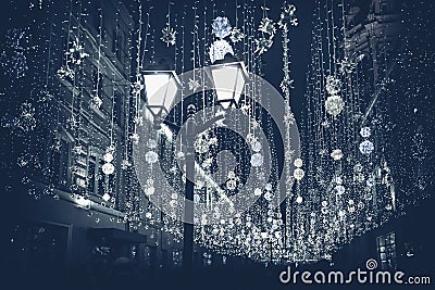 Abstract monochromatic Christmas street with illumination, burning lantern closeup, Christmastide, modern background Stock Photo