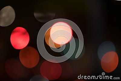 Abstract multi-colored bokeh balls floating across a dark background Stock Photo