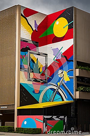 Abstract mural featuring an array of vibrant colors and shapes painted on an exterior wall Editorial Stock Photo