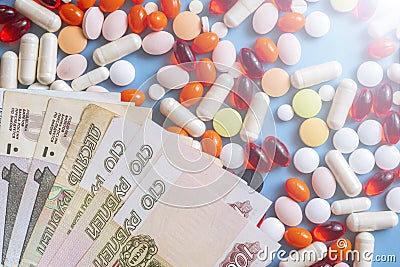 Pharmacy background. Business finance. Russian money and pills on blue backgrouind. Stock Photo