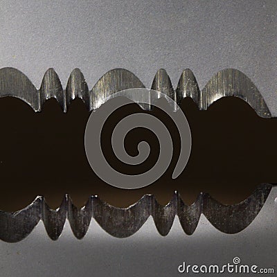 Abstract photo showing in close up serrations on a knife reflected in black plastic Stock Photo