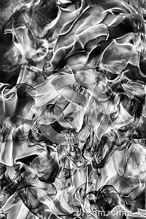 Abstract puffs of natural black smoke and white huge flame of strong fire design. Black and white photography. Dangerous firestorm Stock Photo