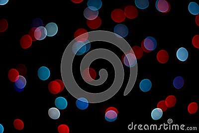 Abstract red and blue bokeh texture on black background. Stock Photo