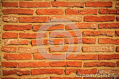 Abstract red brick old wall texture background. Ruins uneven crumbling red brick wall background texture. Stock Photo