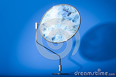 Abstract Round Marble Circle On Metallic Stand on Blue Background. Copy Space. Empty Space. 3d Rendering. Stock Photo