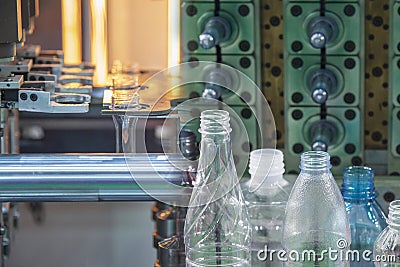 The abstract scene of preform shape of plastic bottles and plastic bottle products. Stock Photo