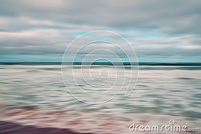 Abstract seascape with blurred panning motion. Overcast day, ocean waves, and cloudy sky. Stock Photo