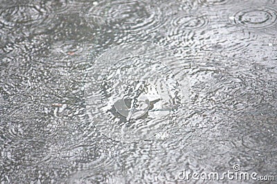 Abstract shot of the raindrops scene on the granite floor. Stock Photo