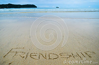 Abstract sign of word friendship written on a sand beach background Stock Photo