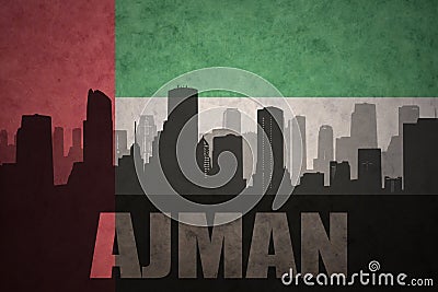 abstract silhouette of the city with text Ajman at the vintage united arab emirates flag Stock Photo