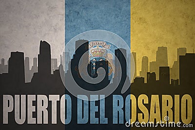 Abstract silhouette of the city with text Puerto del Rosario at the vintage canary islands flag Stock Photo