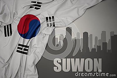 Abstract silhouette of the city with text Suwon near waving national flag of south korea on a gray background Stock Photo