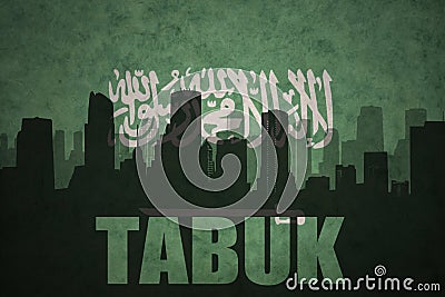 Abstract silhouette of the city with text Tabuk at the vintage saudi arabia flag Stock Photo