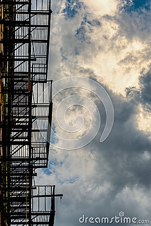 Abstract Fire escape silhouette and cloudy skies Stock Photo