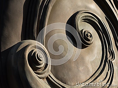 Abstract spirals at the back of a bronze monument Stock Photo