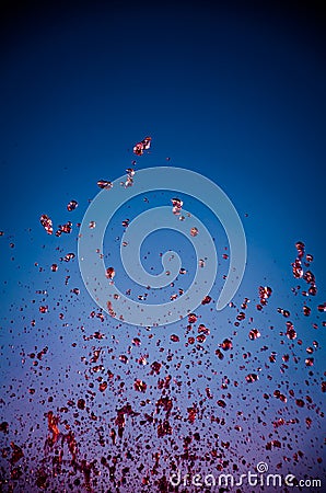 Abstract splashes of red liquid on blue background Stock Photo