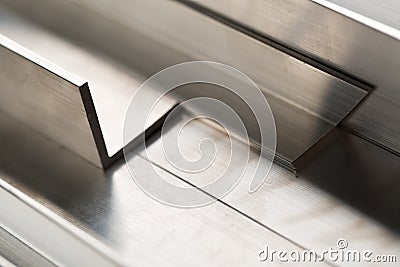 Abstract stack of aluminium profiles close up, industrial background macro Stock Photo