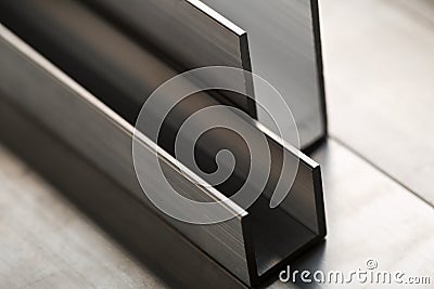 Abstract stack of aluminium profiles close up, industrial background macro Stock Photo