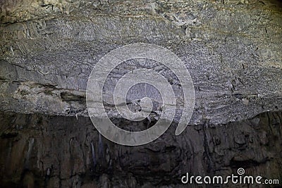 Abstract stone background. Rock formations on the arches and walls of the hall in the cave. Grey grunge textured Stock Photo