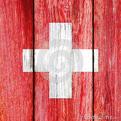 Grunge pattern of Switzerland national flag isolated on weathered wooden fence board. Stock Photo