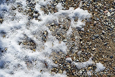 Abstract background photo of melting snow on gravel Stock Photo