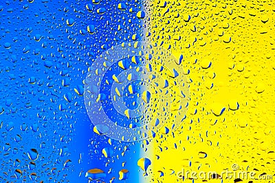 Abstract texture. Water drops on glass with blue and yellow background Stock Photo