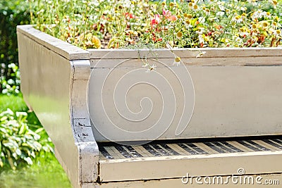 Abstract upright pianos in wood with flowers Stock Photo