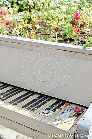 Abstract upright pianos in wood with flowers. Vertical Stock Photo