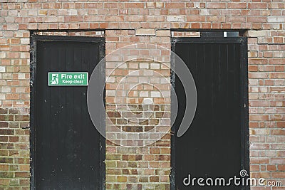 Abstract view of a pair of wooden doors leading to a retail shop's stock room. Stock Photo