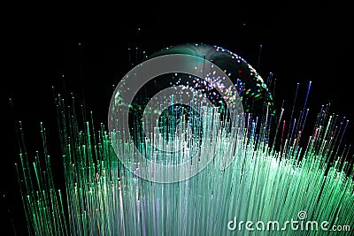 Abstract background with colored fibers optics reflected on glass sphere Stock Photo