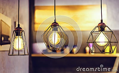 Abstract warm lights hanging from ceiling in local restaurant Stock Photo