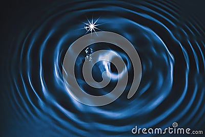 abstract water drop splash with graphic motion flow ripple above dark navy blue background 3D art screen Stock Photo