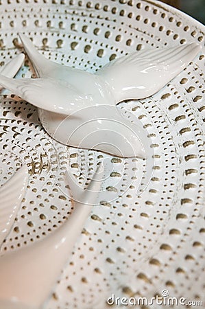 White ceramic bird on decorative plate decoration Stock Photo