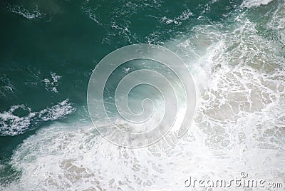 Abstract wild coast line with crashing waves shot from above. Stock Photo