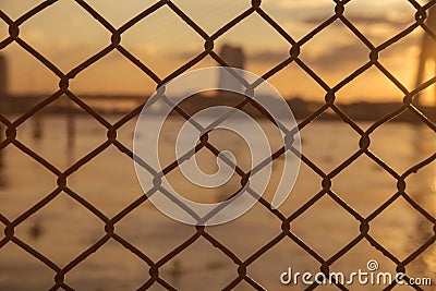 Abstract Wire Rod Wire Mesh background Warm sunshine View of river bridge Stock Photo