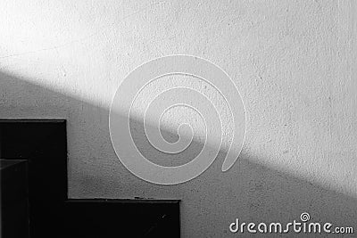 Abstracted light and shadow on the wall next to the stairs Stock Photo