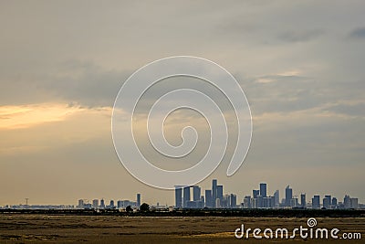 Abu Dhabi city skyscrapers from distance covered with clouds Stock Photo