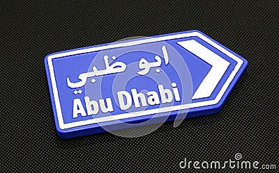 Abu Dhabi directional arrow on black. Stock Photo