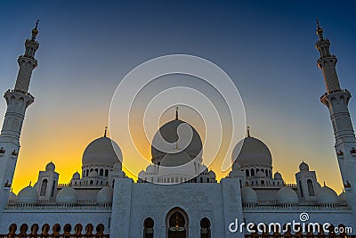 The Sheikh Zayed Grand Mosque symmetrical exterior in Abu Dhabi during golden sunset Stock Photo