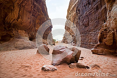 Fallen rock laying in the sand Abu Kashaba Canyon, Wadi Rum, Jordan Desert Stock Photo