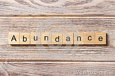 Abundance word written on wood block. abundance text on table, concept Stock Photo